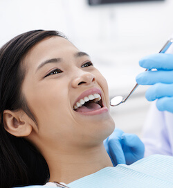 Close-up image of dentist using mouth mirror during check-up