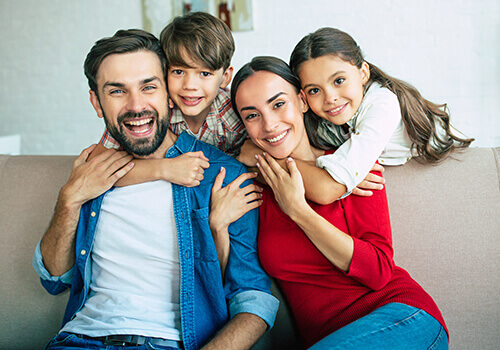 We offer ethical and comprehensive dentistry in Caldwell ID A family hugging and smiling