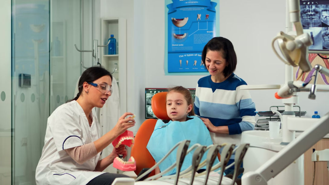 dentist explaining to child and parent