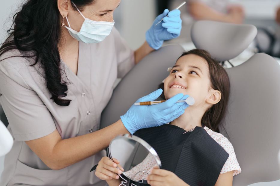 dentist holding tools and child